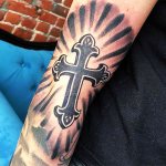 Cross tattoo on arm